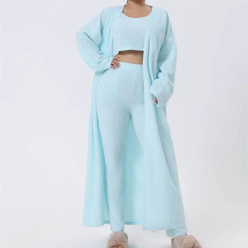 Woman in soft pink cozy pajama set with crop top, wide-leg pants, and long cardigan